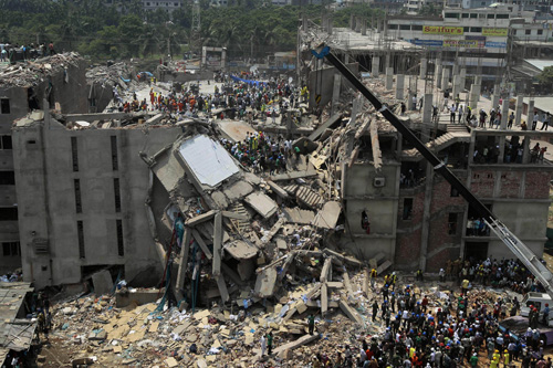 Bangladesh rescuers look for survivors and victims at the site of a building that collapsed Wednesday in Savar, near Dhaka, Bangladesh,Thursday, April 25, 2013. By Thursday, the death toll reached at least 194 people as rescuers continued to search for injured and missing, after a huge section of an eight-story building that housed several garment factories splintered into a pile of concrete. (AP Photo/A.M.Ahad)